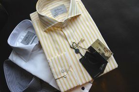 Colorful fashionable men's cotton shirts at dark background
