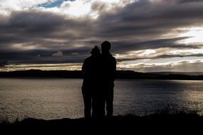 romantic couple by the lake in the evening