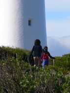 girl and child go to the lighthouse