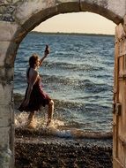 lucky woman walking on sea beach