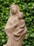 sculpture of maria in a garden