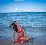 girl in a red bathing suit on the beach