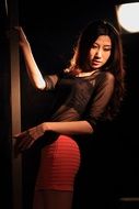 long haired asian girl posing at pole
