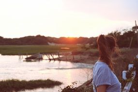 girl is looking to the sides of the lake