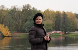 adult woman in autumn park near the pond