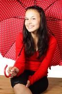 Happy cute girl under red umbrella