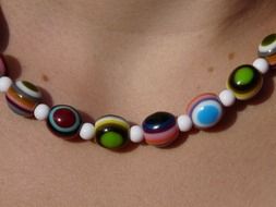 necklace of multi-colored stones on the neck