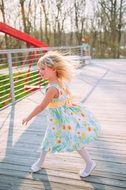 girl in white dress in the wind