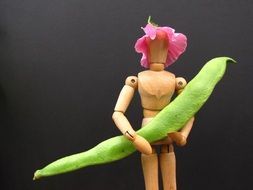 dummy with green beans in hands