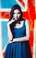 girl in a blue dress against the background of a colorful wall