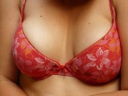 women's breasts in a flowery bra