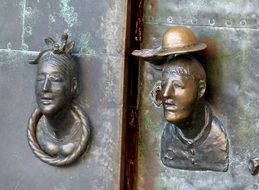 bronze figures on the front door