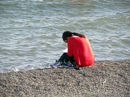 girl reads a book on the seashore