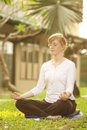 Woman is meditating near Dhammakaya Pagoda