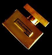 gold perfume on a black background