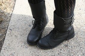 black leather boots on women's feet