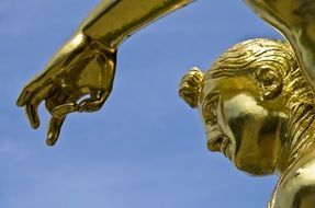 head and hand of golden woman statue, germany, hanover