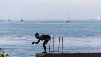 girl is preparing to jump into the water