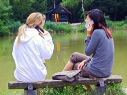girls with phones in the park