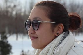 girl in sunglasses on the street in winter
