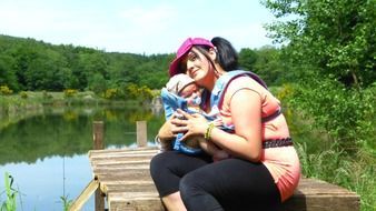 woman with a small child near the pond