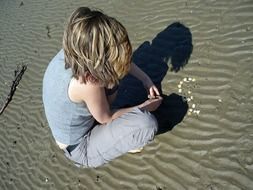 woman and her shadow on the beach of the north sea