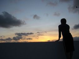 silhouette of a woman meeting sunrise