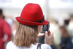 girl in a red hat and a camera