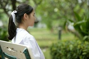 girl meditating on the bench