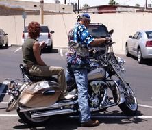 man with woman on a motorcycle harley davidson