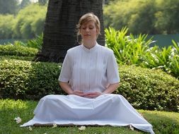 meditate woman in a white dress outdoor