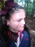 girl with dirty face on the background of the forest