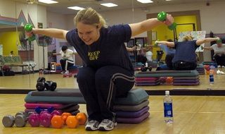 woman lifting power dumbbells