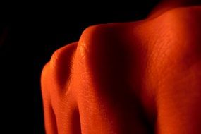 women knuckle in red light, macro