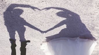 Shadows of wedding couple on a sand