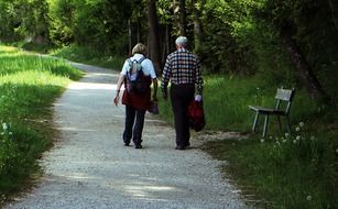 man and woman walking in the Park