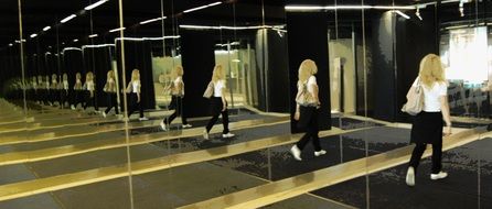 Reflection of a running blonde in the mirrors