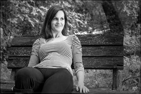 black and white image of a woman on a bench