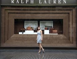 girl posing in front of showcase