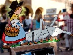 drawing of a woman with geese on a plate