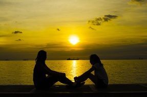 Silhouettes of the children and sunset