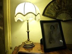 old romantic lamp on the dresser with a photo