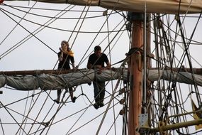 people on the mast of the ship