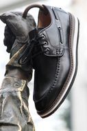 men's boot in the hand of the monument