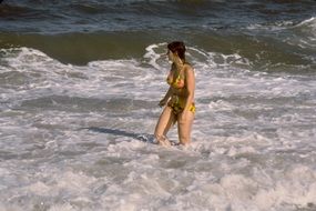 wading woman in the ocean