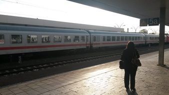 woman on the platform at the train station on a sunny day