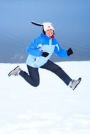 cheerful girl jumping in winter