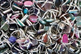 heap of silver rings with gemstones