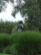 stone statue in high grass