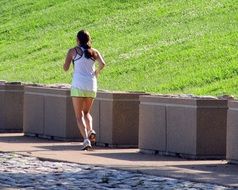 young woman jogging in the sunny morning